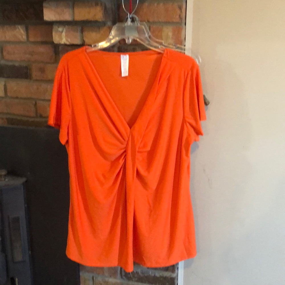 1x/1T orange short sleeved blouse.